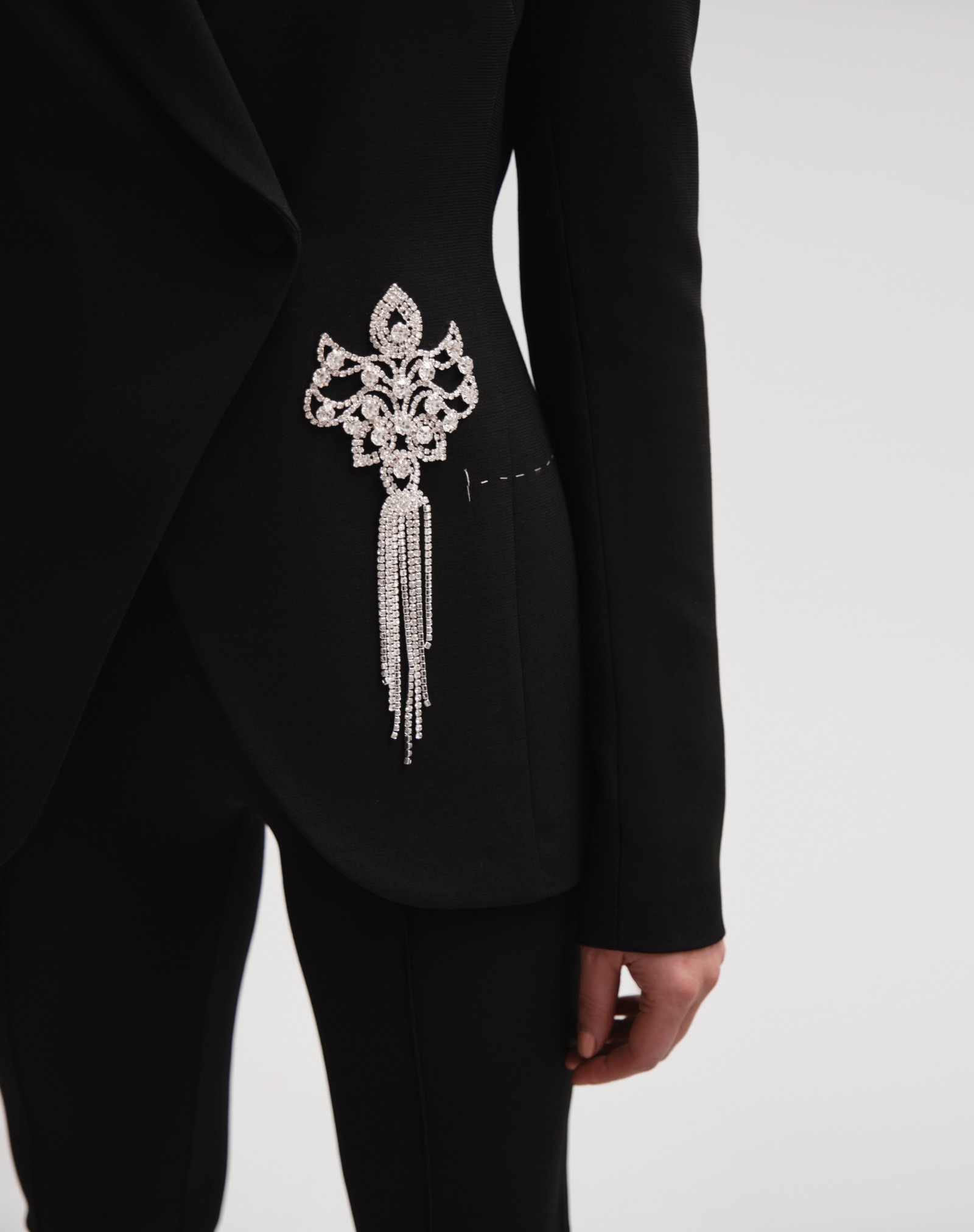 Asymmetrical women's jacket with a brooch in black